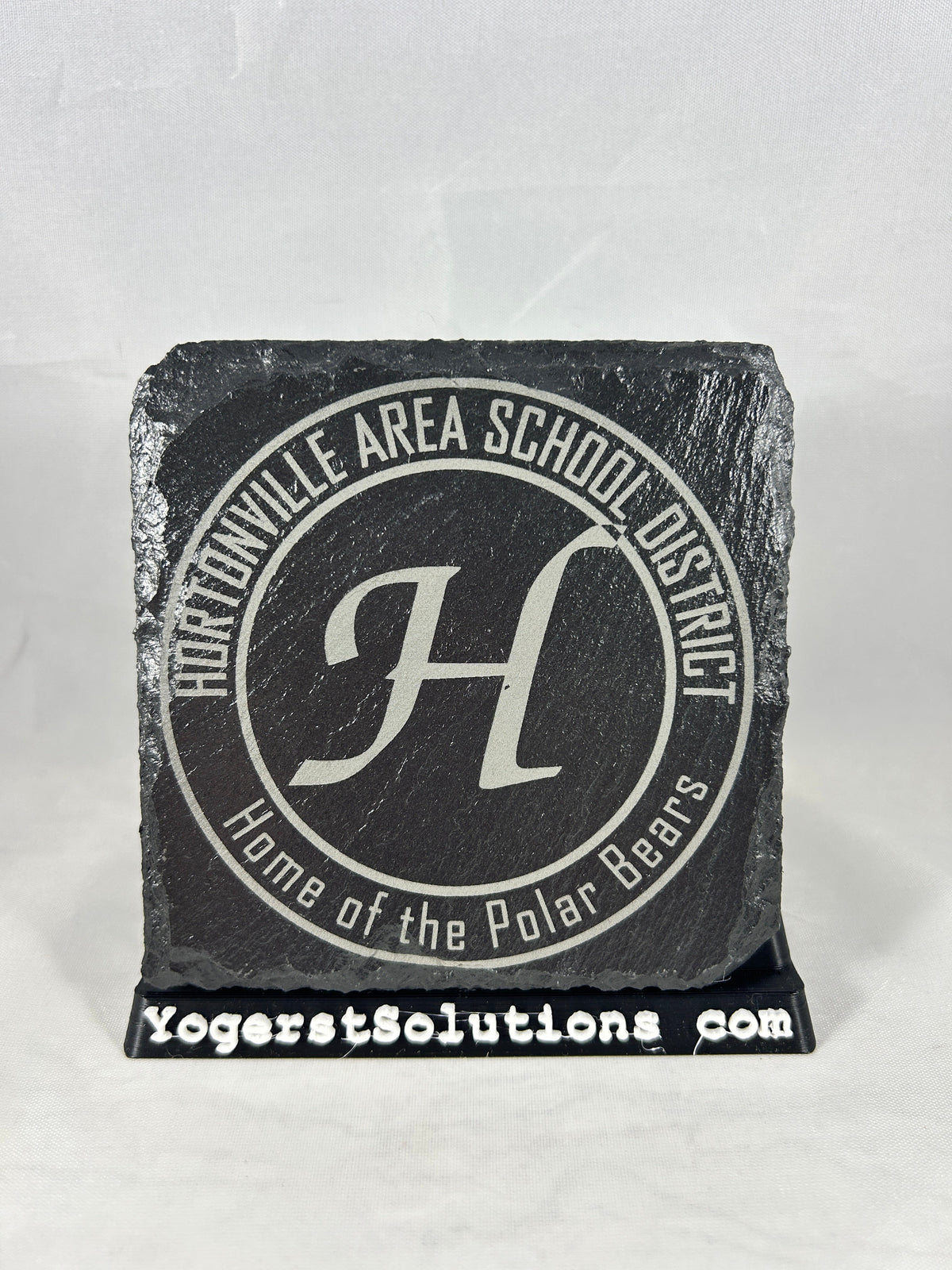 Hortonville Area School District seal engraved on slate with a Yogerst Solutions stand