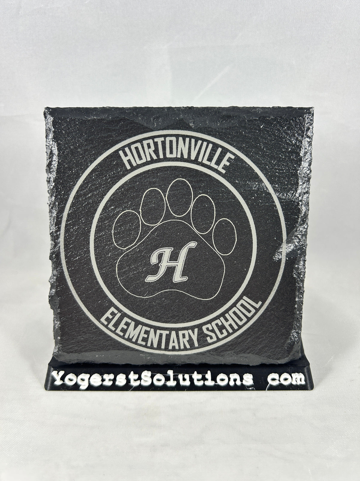 Hortonville Elementary School paw logo engraved on slate with a Yogerst Solutions stand