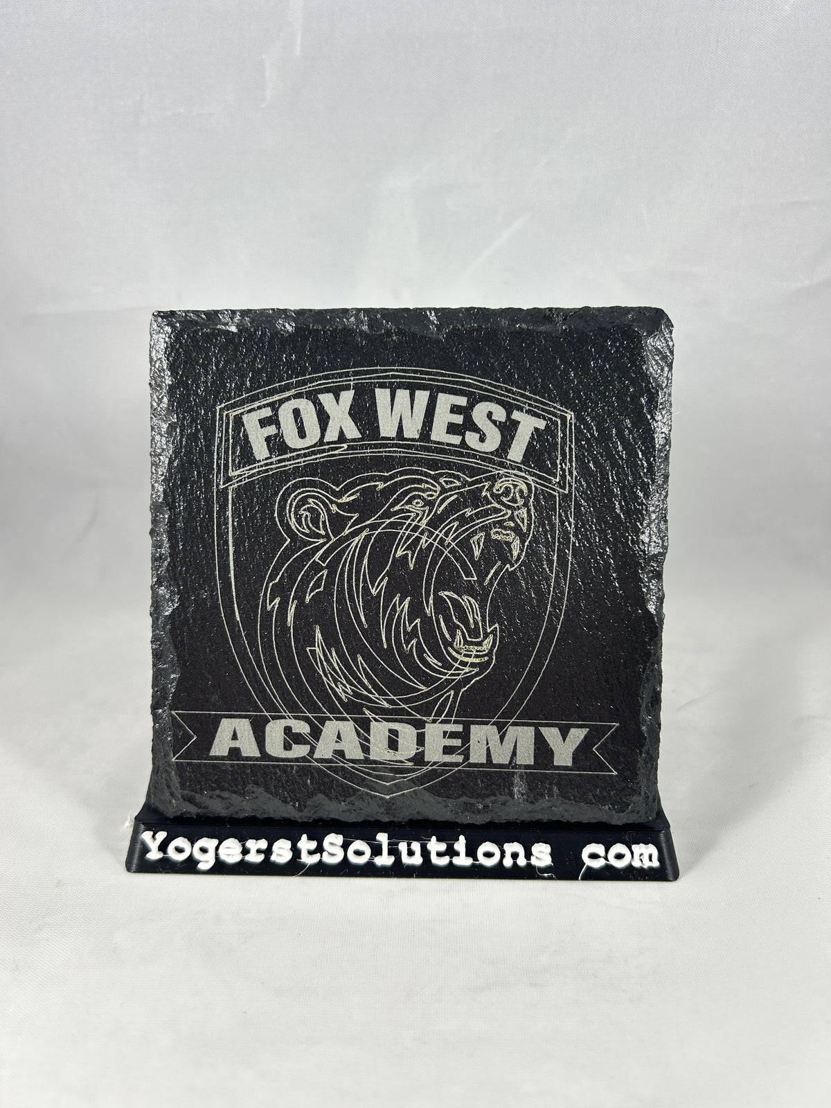 Fox West Academy bear shield engraved on slate with a Yogerst Solutions stand